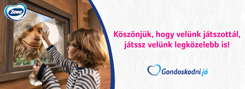 Egy fiú egy barátságos lényt érint meg az ablakon keresztül, egy részvételt megköszönő üzenettel a jobb oldalon.