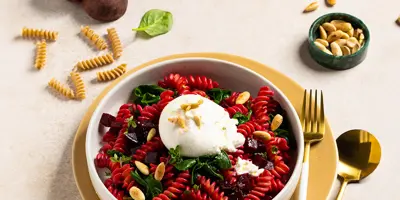 Beetroot pasta with spinach, burrata and roasted almonds